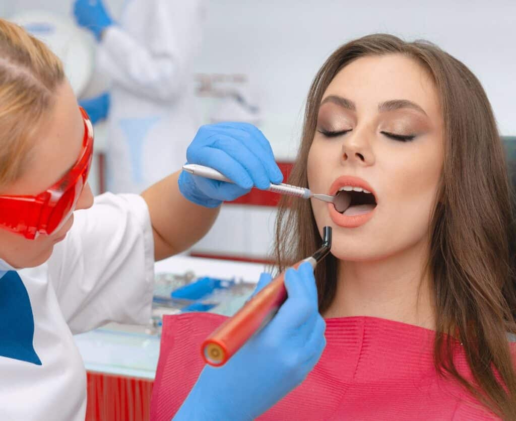 Dental professional performing restorative treatment on a patient, showcasing tools and techniques used for dental restoration at Hastings Dental Centre.